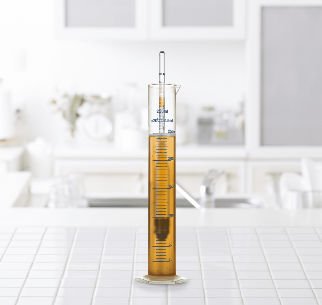 plastic hydrometer on white counter